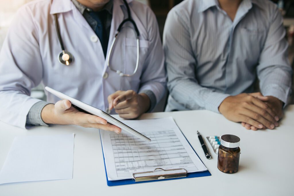 Doctor is explaining a bill to a patient after treatment.